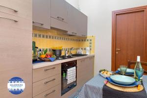a kitchen with a table with a bowl of fruit on it at SALERNUM - MONTE MARE in Salerno
