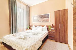 a bedroom with a bed and a large window at Forum Hotel in Szombathely