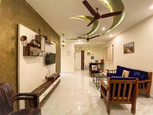 a living room with a ceiling fan and a couch at Moroccan Suite Calangute Beach Vibe in Calangute