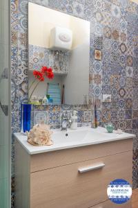 a bathroom with a sink and a mirror at SALERNUM - MONTE MARE in Salerno