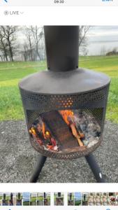 a grill with a fire inside of it at Fox's Den in Bathgate