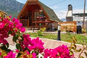 a small house with pink flowers in front of it at ADRASAN HİMERA APART & BUNGALOW in Adrasan