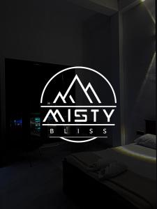 a bedroom with a nisely files logo on a wall at Misty Bliss in Ella