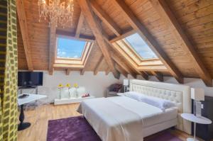 a bedroom with a large white bed and wooden ceilings at Villa Massari in Milan