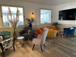 a living room with a couch and chairs and tables at Hotel La Tuiliere in Carry-le-Rouet