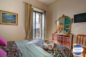 a bedroom with a bed and a mirror and a dresser at SALERNUM - MONTE MARE in Salerno