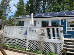 a small house with solar panels on the roof at Wu Wu's Cabins in Wasaga Beach