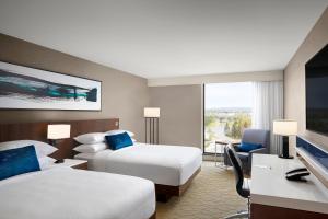 a hotel room with two beds and a television at Delta Hotels by Marriott Thunder Bay in Thunder Bay