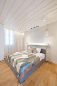 a bedroom with a large bed with towels on it at αυλή Ναύπλιον in Nafplio +22 photos