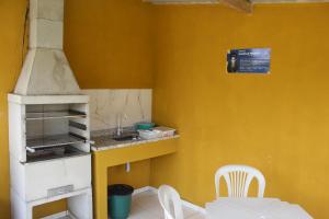 uma pequena cozinha com um lavatório e um fogão em Kitnet Apto em Cabo Frio RJ - Recanto das Corujas em Cabo Frio