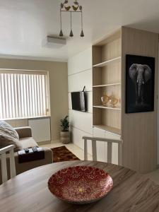 una sala de estar con una mesa y una foto de elefante en Apartamento no centro de Curitiba,bem localizado e confortável, en Curitiba
