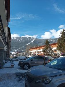 a parking lot with cars parked in front of a mountain at Maisonnette au cœur des Angles in Les Angles