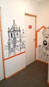 a room with a door with a drawing on the wall at Al-Xelb guesthouse in Silves