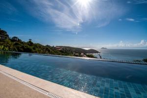 a swimming pool with a view of the ocean at Buzios Mar Hotel in Búzios