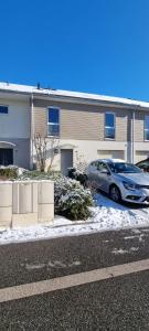 a car parked in a parking lot in front of a building at Chambre confortable chez l'habitant in Saint Pierre en Faucigny