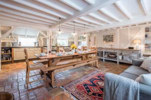 a living room with a wooden table and a couch at Ivy House Mells in Halesworth