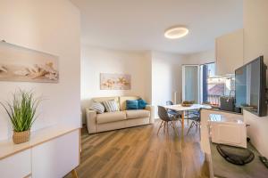 a living room with a couch and a table at Ferrari Apartments Levante in Caorle