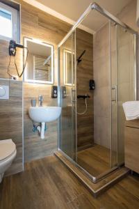 a bathroom with a shower and a sink at Pano Kopaonik Panorama in Kopaonik