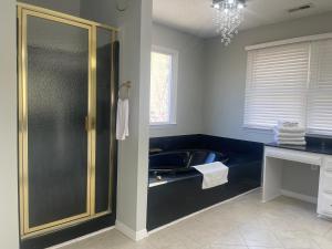 a bathroom with a tub and a sink at Mountain Bliss Retreat near Asheville & Charlotte in Kings Mountain +37 photos