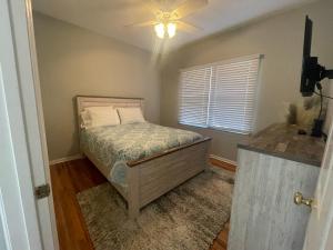 a bedroom with a bed and a ceiling fan at Mountain Bliss Retreat near Asheville & Charlotte in Kings Mountain
