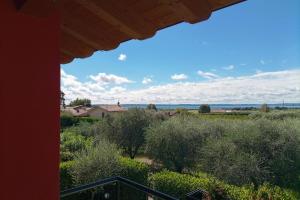a view from the balcony of a house with trees and bushes at Bardolino Suite in Bardolino