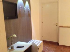 a room with a white desk and a tv on a wall at Antica Melegnano in Atri +19 photos