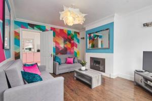 a living room with a couch and a fireplace at Central Nottingham house in Nottingham