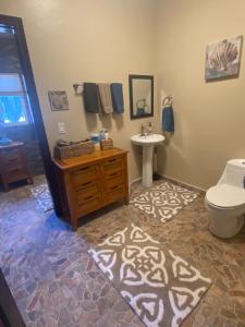 a bathroom with a toilet and a sink at Dolphin Beach Get Away in Rosarito