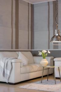 a living room with a white couch and a table at City Central in Ljubljana