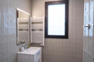 bagno con servizi igienici, lavandino e finestra di Feelathome Stadium Apartments a Hospitalet de Llobregat