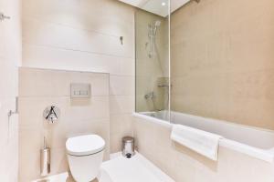 a bathroom with a toilet and a shower and a tub at Montesun RAF Apartments in Budva