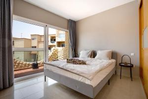 a bedroom with a bed and a large window at Relax y confort en Costa Calma in Pájara +17 photos