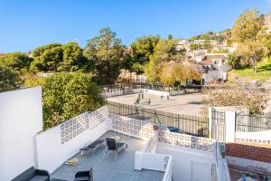 a view of a patio with chairs and a park at Torremuelle - Apartment with private pool & BBQ in Benalmadena in Benalmádena