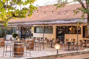 an outdoor restaurant with tables and chairs and lights at Le Bois d'Imbert in Rocamadour