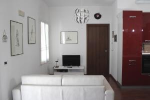un soggiorno con divano bianco e TV di Torre del Po - locazione breve a Guarda Veneta