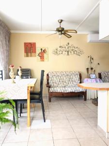 a dining room with a table and a chair at JoThams Bed & Breakfast or Self-catering in Durban