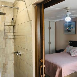 a bedroom with a shower and a bed and a shower at JoThams Bed & Breakfast or Self-catering in Durban