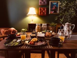 a table with a breakfast of food and orange juice at Beautiful B&B On The Park in Belfast