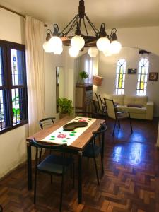 a dining room and living room with a table and chairs at Nossa Casa Novo Hamburgo in Novo Hamburgo