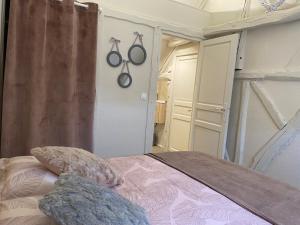 a bedroom with a bed and some pans on the wall at L'éloge de Vouvray, Orbois in Vouvray