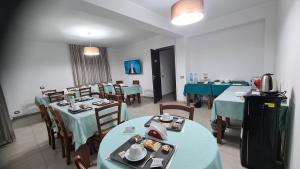 a dining room with blue tables and chairs at Idilliaco inn in Motta SantʼAnastasia