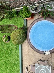 an overhead view of a swimming pool with grass at Splendid house, Jacuzzi and Private Gardens Paris in Boulogne-Billancourt