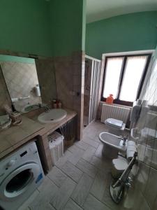 a bathroom with two sinks and a washing machine at La Voce della Natura in Fermo