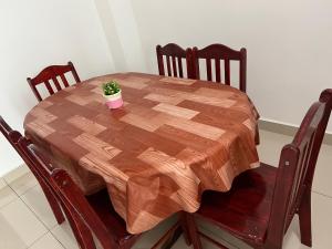 una mesa de madera con una maceta encima en De Pontian Homestay, en Pontian Besar