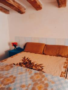 a bedroom with a bed with a blanket on it at Sidharta Room in Villalba dels Arcs