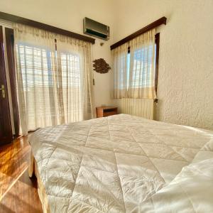 A bed or beds in a room at Villa Naya by the Beach