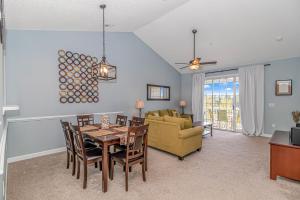 a dining room and living room with a table and a couch at Barefoot Beach Haven at Barefoot Resort & Golf - 3rd Floor- Close to Everything in North Myrtle Beach