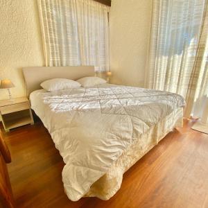 A bed or beds in a room at Villa Naya by the Beach