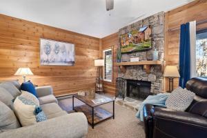 a living room with a couch and a fireplace at Beautiful Seven Springs- 2 Bed, 2 Bath Condo in Champion