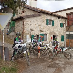 a group of people on dirt bikes in front of a building at La Corte dei Celti in San Benedetto Del Querceto